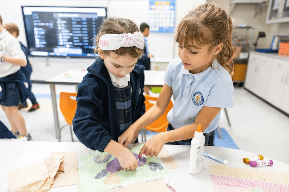 Two girls working on an art project.