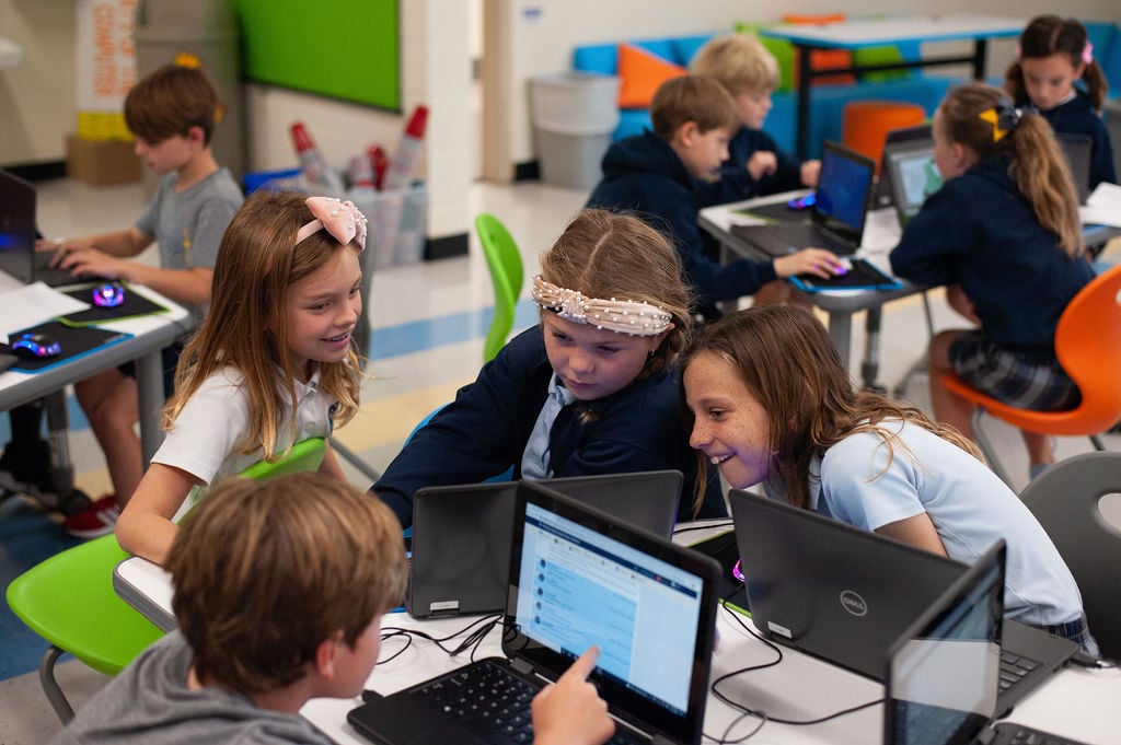 Students doing an activity on laptops.