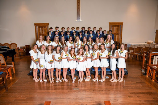 St. Mary's students posed on risers during 8th grade graduation.