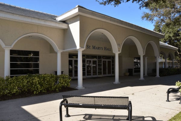 The entrance of the hall building with benches and pillars.